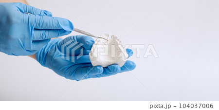 Orthodontic dental theme on blue background.Transparent invisible dental aligners or braces aplicable for an orthodontic dental treatment Orthodontic dental theme on blue background.Transparent invisible dental aligners or braces aplicable for an orthodontic dental treatment 104037006