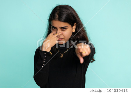 Indian woman pointing at her eyes and camera show I am watching you gesture spying watching someone 104039418