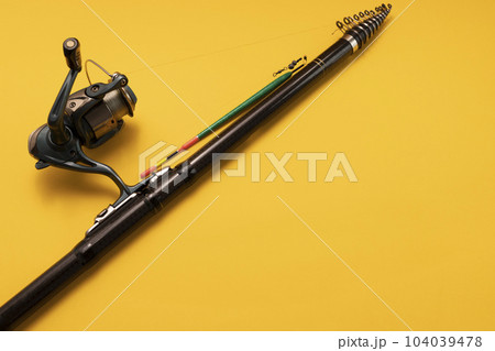 Mockup Fishing Spinning Rod, Reel on Yellow Background. Hobby, Leisure. Copy Space for Text On Right. Horizontal Plane 104039478