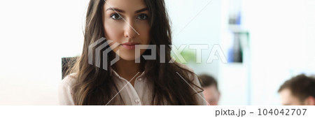 Portrait of young businesswoman in the background is employee working Portrait of young businesswoman in the background is employee working 104042707