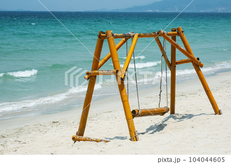 Swing on seashore. Summertime tropical beach. 104044605