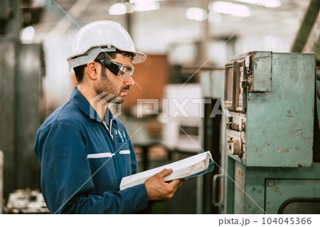 New Engineer Worker Reading User Manual Machine Instruction Guide Book to Working Operate Solving Problem in Metal Factory. 104045366