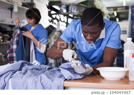Laundry worker during daily work 104045987