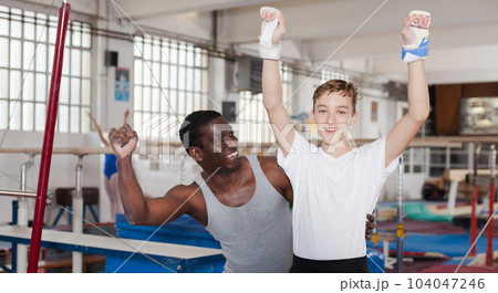 Coach happy with his teenage athlete Coach happy with his teenage athlete 104047246