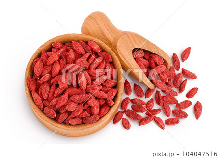 Dried goji berries in wooden bowl and scoop isolated on white background. Top view. Flat lay. 104047516