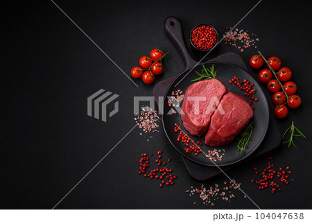 Raw beef eye steak round with salt, spices and herbs Raw beef eye steak round with salt, spices and herbs 104047638