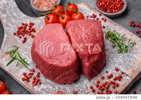 Raw beef eye steak round with salt, spices and herbs Raw beef eye steak round with salt, spices and herbs 104047646
