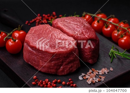 Raw beef eye steak round with salt, spices and herbs Raw beef eye steak round with salt, spices and herbs 104047700