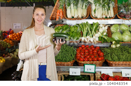 Smiling woman is choosing vegetables 104048354