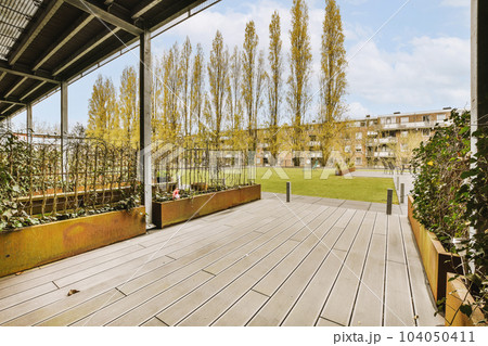 an outdoor area with wooden decking and trees in the background on a bright sunny day, taken from above an outdoor area with wooden decking and trees in the background on a bright sunny day, taken from above 104050411
