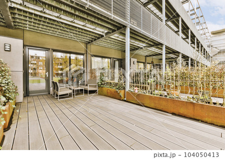 an outdoor patio with plants and potted trees on the deck, as well as it is in the daytime an outdoor patio with plants and potted trees on the deck, as well as it is in the daytime 104050413