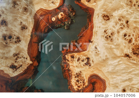 The surface is made of resin and wood. Liquid epoxy resin is poured into a mold with wooden boards. with space to copy. High quality photo The surface is made of resin and wood. Liquid epoxy resin is poured into a mold with wooden boards. with space to copy. High quality photo 104057006