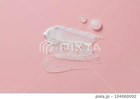 Many cosmetic products samples with vitamin C - cream and gel smears. Aesthetic beautiful textured smear transparent on light background 104060092