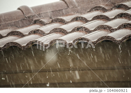 rain falling down from the house roof 104060921