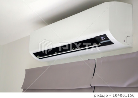 Air conditioner on white wall room interior background Air conditioner on white wall room interior background 104061156