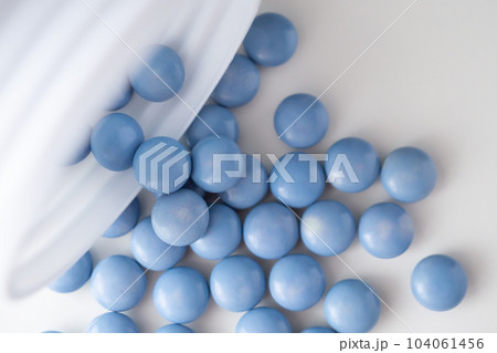 blue medicine pills with bottle on white background 104061456