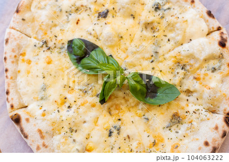 Fragrant Italian pizza of four cheeses - parmesan, dor blue, mozzarella, cheddar, Close up, top view. 104063222