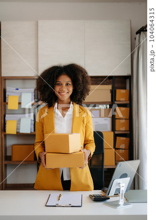 Small business entrepreneur SME freelance woman working at home office, BOX,tablet and laptop online, marketing, packaging, delivery, e-commerce concept. Small business entrepreneur SME freelance woman working at home office, BOX,tablet and laptop online, marketing, packaging, delivery, e-commerce concept. 104064315