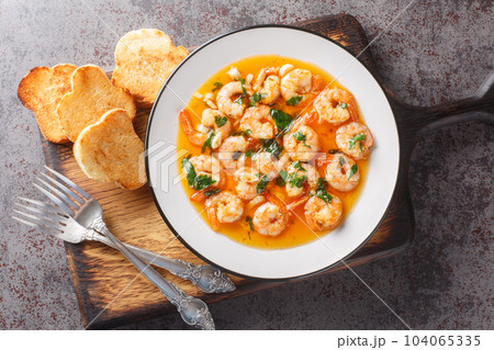 Tasty Prawns with Garlic Gambas Al Ajillo closeup. Horizontal top view Tasty Prawns with Garlic Gambas Al Ajillo closeup. Horizontal top view 104065335