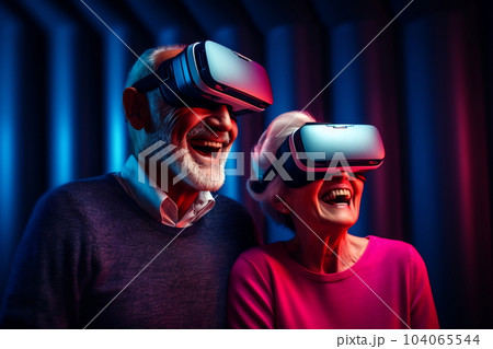 Senior mature couple having fun with virtual reality glasses. Old people using new headset goggles trends technology Senior mature couple having fun with virtual reality glasses. Old people using new headset goggles trends technology 104065544