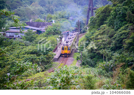 A yellow diesel train stops next to the platform of Lingjiao Station. A yellow diesel train stops next to the platform of Lingjiao Station. 104066086