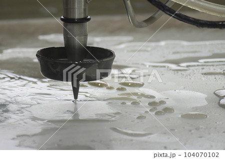 Close-up scene of multi-axis abrasive waterjet cutting machine cutting the aluminum plate. Close-up scene of multi-axis abrasive waterjet cutting machine cutting the aluminum plate. 104070102