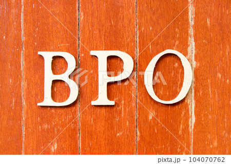 Alphabet letter in word BPO (Abbreviation of Business Process Outsourcing) on old red color wood plate background Alphabet letter in word BPO (Abbreviation of Business Process Outsourcing) on old red color wood plate background 104070762