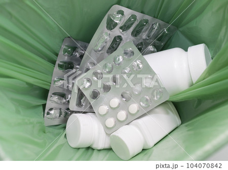 Closeup Garbage Can, Trash Bin Full Of Medication. Pills, Tablet Bottles, Empty Capsule Pastilles. Medical Waste, Supplement Over Consumption Concept. Pharmacy. Horizontal Plane Closeup Garbage Can, Trash Bin Full Of Medication. Pills, Tablet Bottles, Empty Capsule Pastilles. Medical Waste, Supplement Over Consumption Concept. Pharmacy. Horizontal Plane 104070842