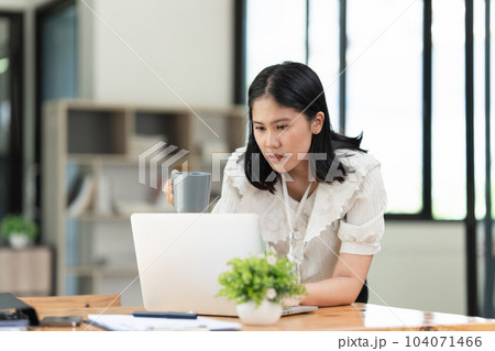 Financier a asian woman works, uses a laptop, makes a report to a finance company. Accounting and financial concept 104071466