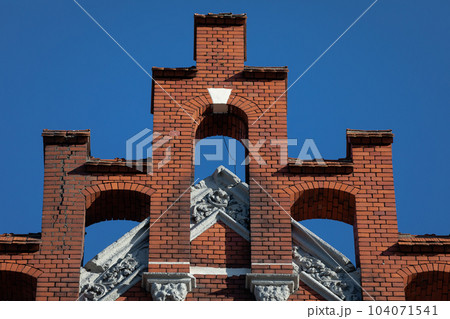 Topping the gable wall of a historic red brick building. Topping the gable wall of a historic red brick building. 104071541