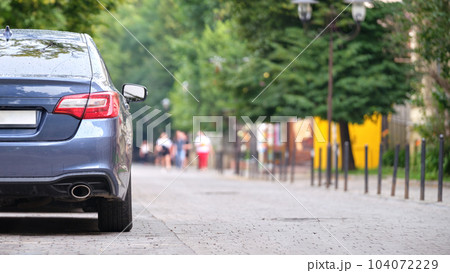 Close up of a car parked illegally against traffic rules on pedestrian city street side 104072229