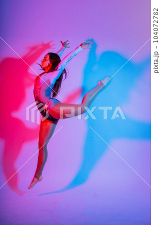 High jump, flight. Little flexible girl, rhythmic gymnastics artist jumping. Grace motion, action. 104072782