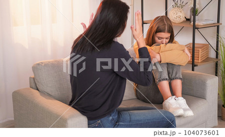 Parents blaming. Behavior talk. Aggressive mother censuring teenage daughter family misunderstanding sitting sofa light home interior. Parents blaming. Behavior talk. Aggressive mother censuring teenage daughter family misunderstanding sitting sofa light home interior. 104073601
