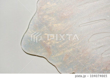 Beauty gel texture with pink and golden particles. Shining highlighter background with brush strokes 104074665