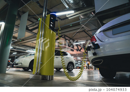 Electric car is charged from the charging station 104074933