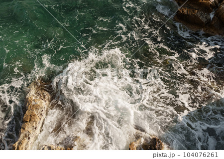 Fresnch Riviera cliffs with sea waves crushing on them 104076261