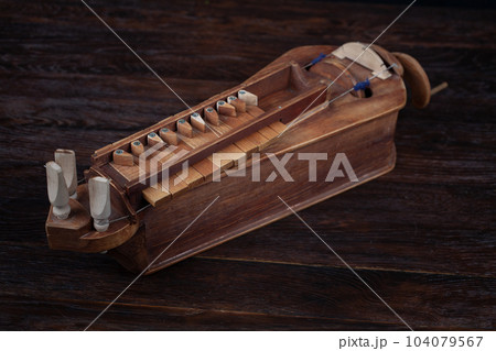 The Hurdy-gurdy, stringed musical instrument. 104079567