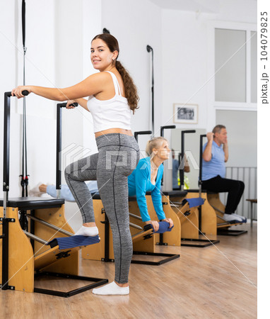 Relaxed young female standing and exercising...の写真素材 [104079825] - PIXTA