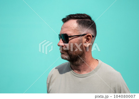portrait of Caucasian man wearing sunglasses, fresh haircut and raw beard 104080007