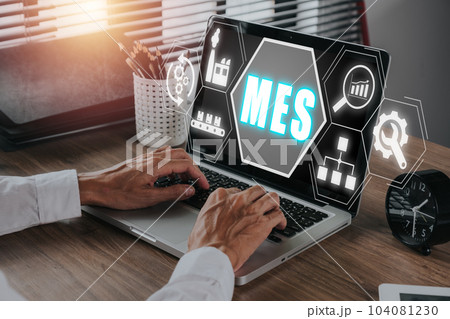 MES, Manufacturing Execution System concept, Businessman working on laptop with Manufacturing Execution System icon on virtual screen. 104081230