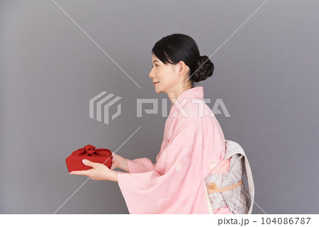 贈り物を持つ着物を着た女性 104086787