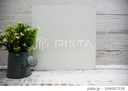 Empty wooden board space for copy and artificial plant decoration on wooden background Empty wooden board space for copy and artificial plant decoration on wooden background 104087338