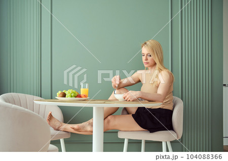 Woman has breakfast at home 104088366