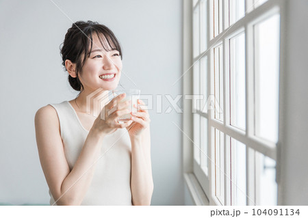 家で朝ミルク・牛乳を飲むアジア人女性 104091134