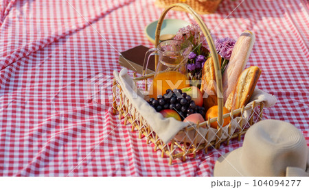 Picnic Lunch Meal Outdoors Park with food picnic basket. enjoying picnic time in park nature outdoor Picnic Lunch Meal Outdoors Park with food picnic basket. enjoying picnic time in park nature outdoor 104094277