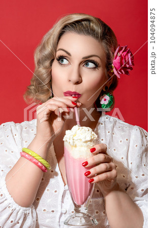Woman drinking milkshake. Portrait of a retro style woman. 104094875