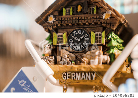 Closeup of carved wooden clock decor with Germany text at ski resort, winter holiday travel concept 104096883