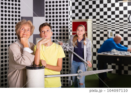 Boy together with the elderly grandmother thought about solving the puzzle in quest room Boy together with the elderly grandmother thought about solving the puzzle in quest room 104097110