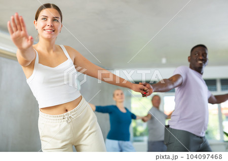Young girl practicing boogie-woogie with african male partner Young girl practicing boogie-woogie with african male partner 104097468