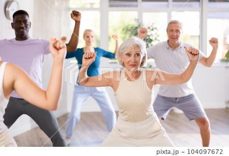Senior woman learning to dance krump in modern choreographic studio Senior woman learning to dance krump in modern choreographic studio 104097672